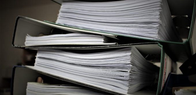 binders stacked full of paperwork